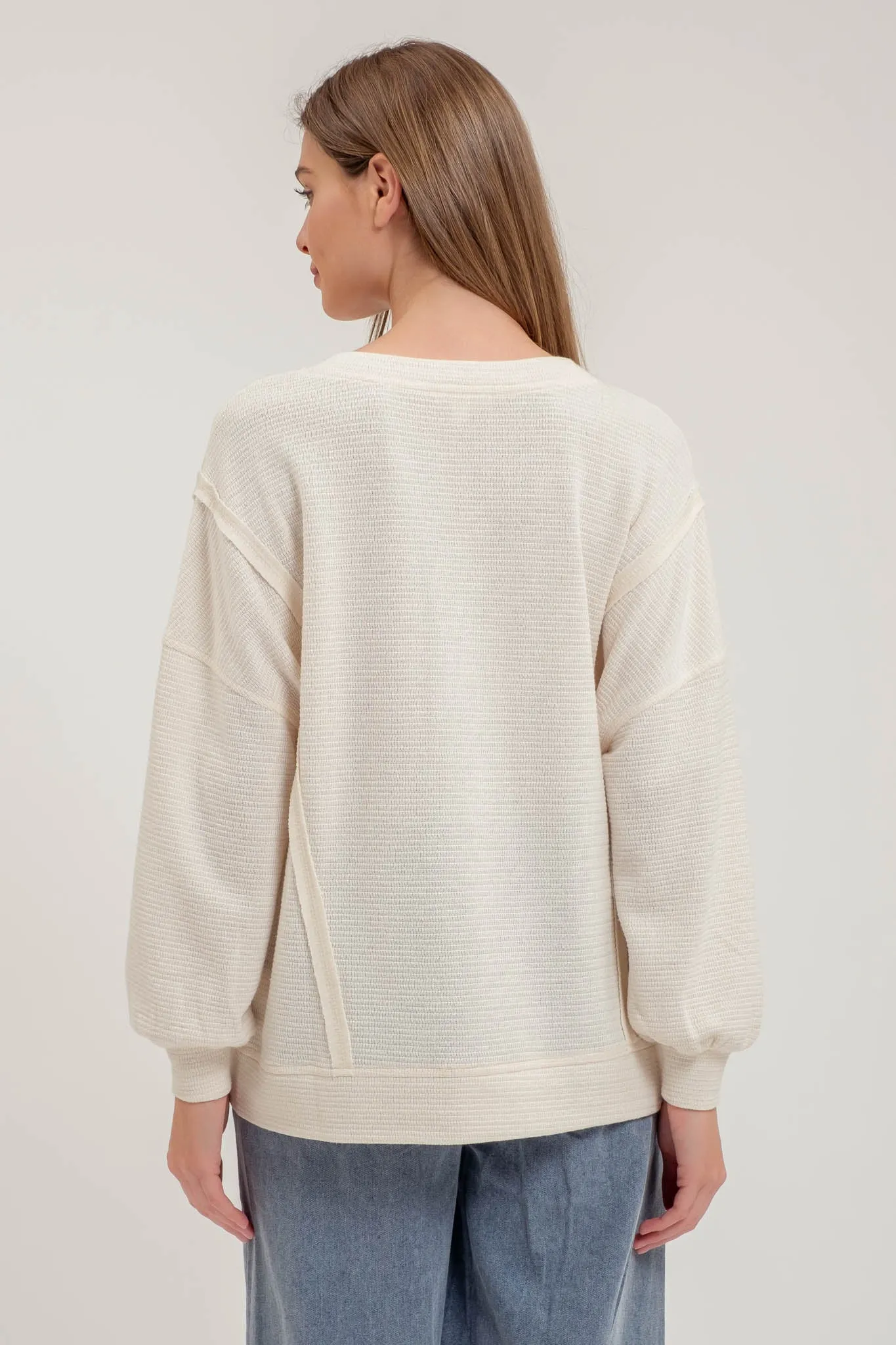 SPLIT NECK EXPOSED SEAM LONG SLEEVE KNIT TOP