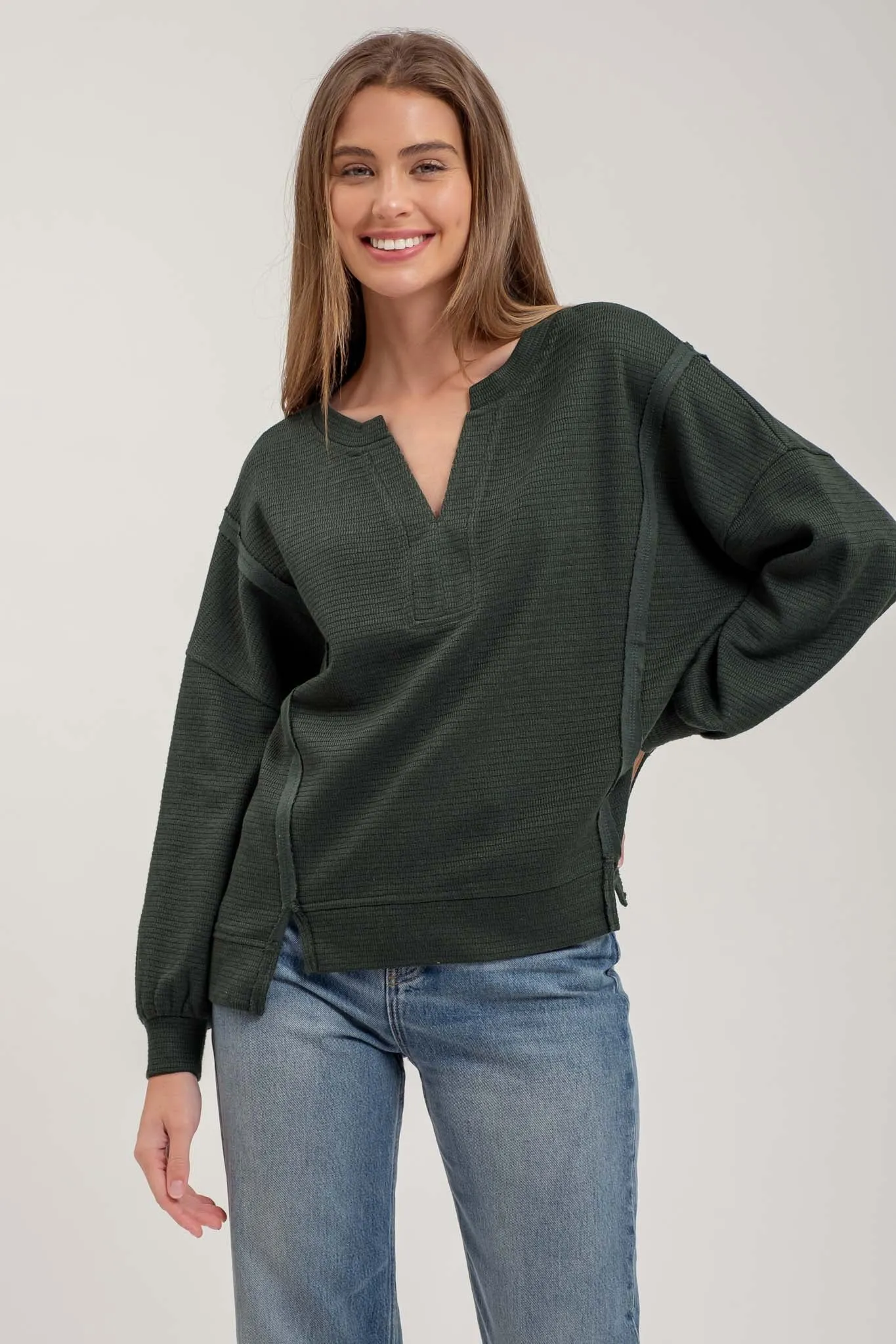 SPLIT NECK EXPOSED SEAM LONG SLEEVE KNIT TOP