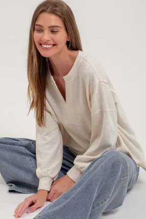 SPLIT NECK EXPOSED SEAM LONG SLEEVE KNIT TOP