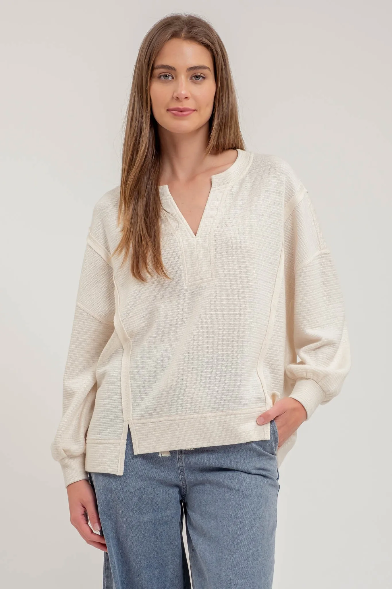 SPLIT NECK EXPOSED SEAM LONG SLEEVE KNIT TOP